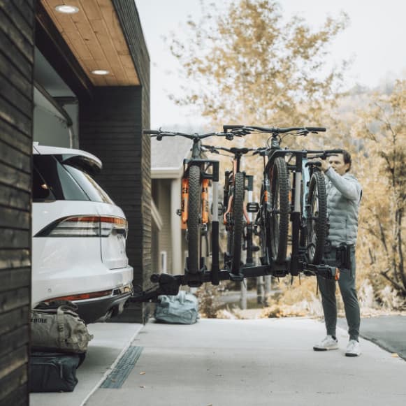 Thule Verse and Thule Verse Add-on installed on back of white SUV with 4 bikes.
