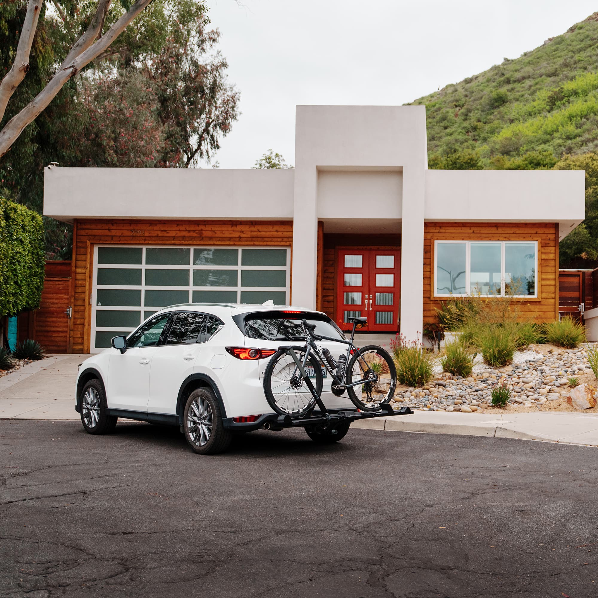 SuperClamp G4 installed on back of SUV parked in front of a house